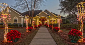 poinsettias line walk way to home decorated for Christmas